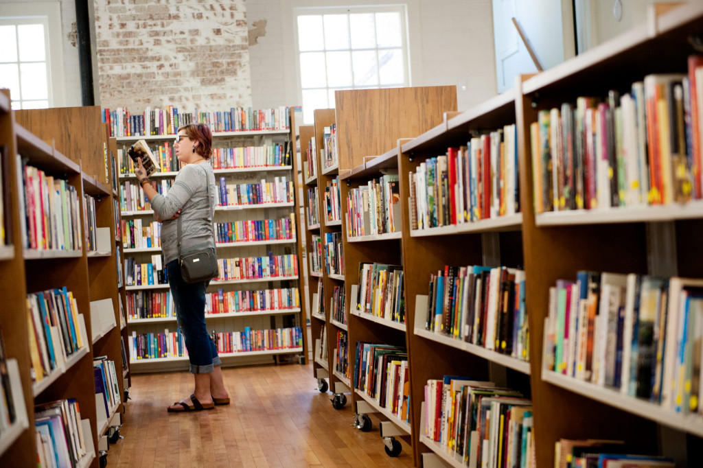 Kristi Newman of Fayetteville browses books on shelves during Opening Day at the Given Outpost on Wednesday, April 1, 2015 in Pinehurst, North Carolina.