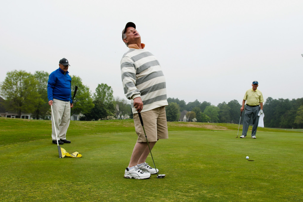 Woody Tanner (left) and Lyle Cooper (right) watch as Bob Lamoree (center) reacts after missing a putt at the one green while playing a round with friends from Midloathian, Virginia at Longleaf Golf and Country Club on Friday, April 17, 2015 in Southern Pines, North Carolina. Lamoree said the group is in the Sandhills for a golf outing, and Friday was their last day.