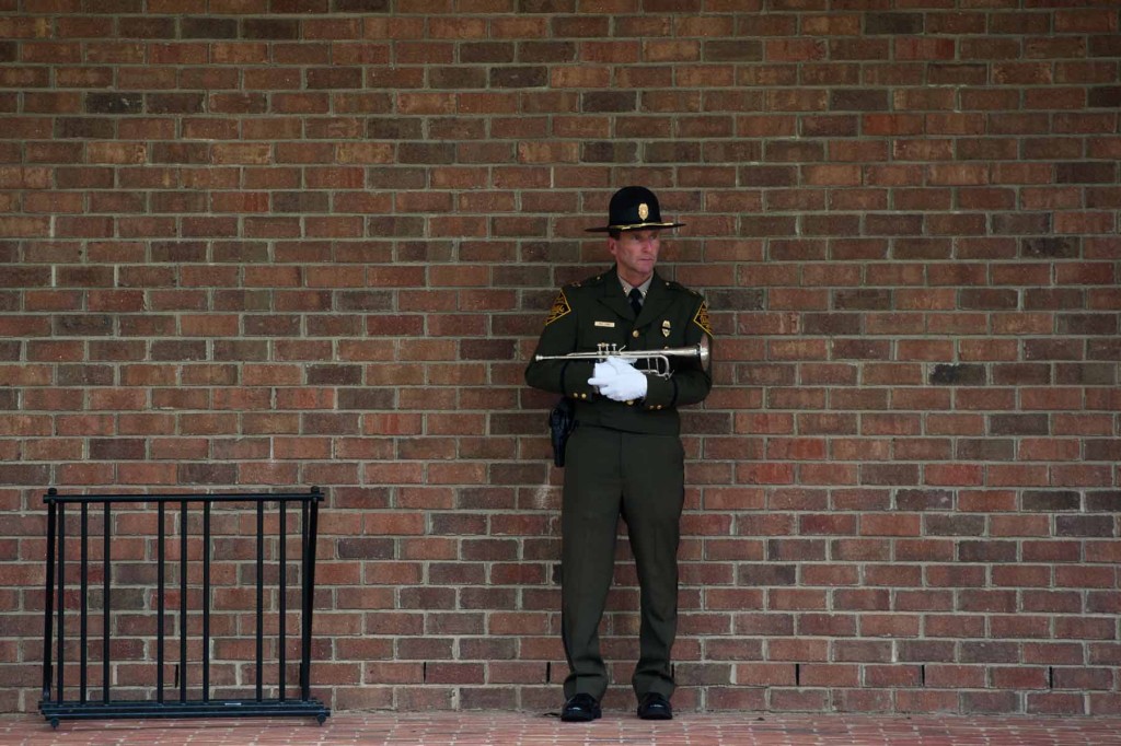 Captain Matt Long, who's with the NC Wildlife Resources Commission, stands near Van Dusen Hall as he waits to perform Taps  during the Moore County Public Safety Memorial Dedication on campus at Sandhills Community College on Friday,  September 11, 2015 in Pinehurst.