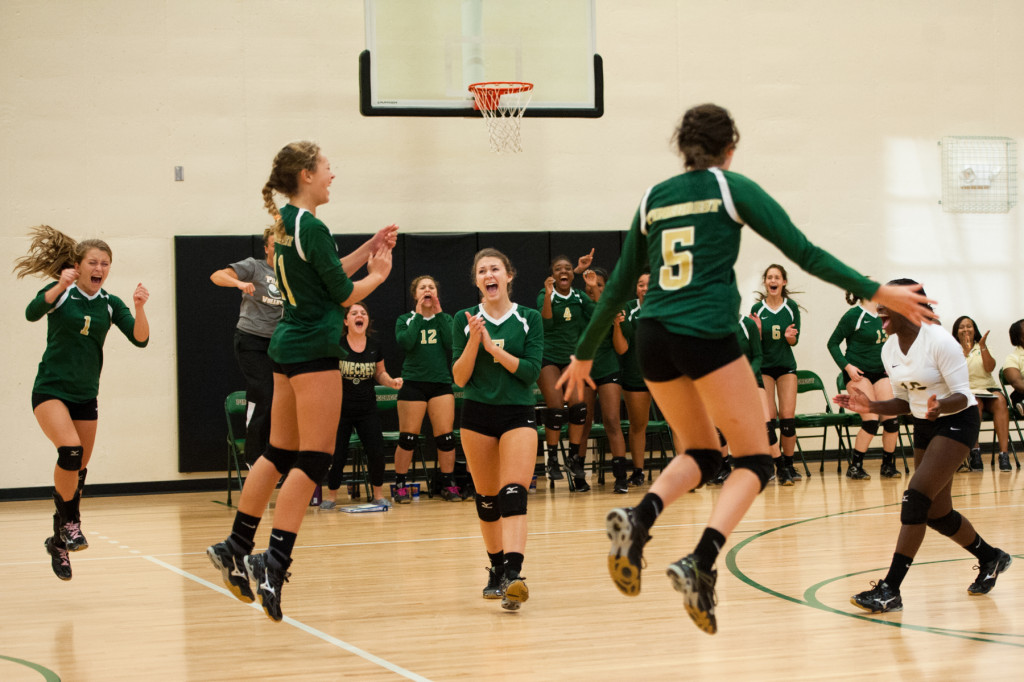 Members of the Pinecrest team celebrate after winning a match during a volleyball match between Pinecrest High's School Junior Varsity team and Jack Britt High School's Junior Varsity team at Pinecrest High School on Wednesday, September 30, 2015 in Southern Pines, North Carolina.