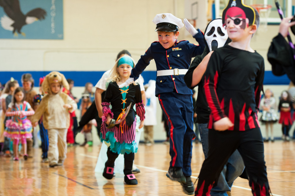 Eli Meyers, dressed as a military member, jumps and laughs as he walks during the Halloween Costume parade in the gymnasium of High Falls Elementary School on Friday, October 30, 2015 in Robbins, North Carolina.