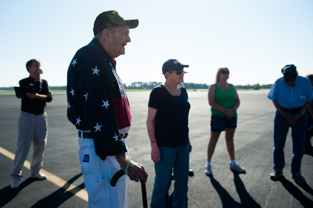 Adrian de Pasquale, DeeDee Miller and other people from the Southern Pines Gracious Living Retirement Community  listen to Founder, President and Pilot of Ageless Aviation Darryl Fisher  before he takes guests on rides in his Boeing Stearman biplane at the Moore County Airport on Tuesday, September 1, 2015 in Whispering Pines.