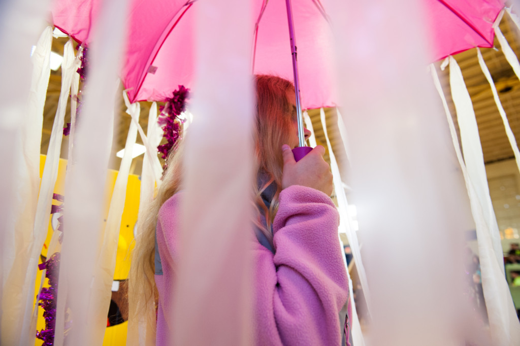 Kaitlyn Garner, wearing a pink sweater and carrying a pink umbrella with pink streamers, walks as a jellyfish during the Halloween Costume parade in the gymnasium of High Falls Elementary School on Friday, October 30, 2015 in Robbins, North Carolina.