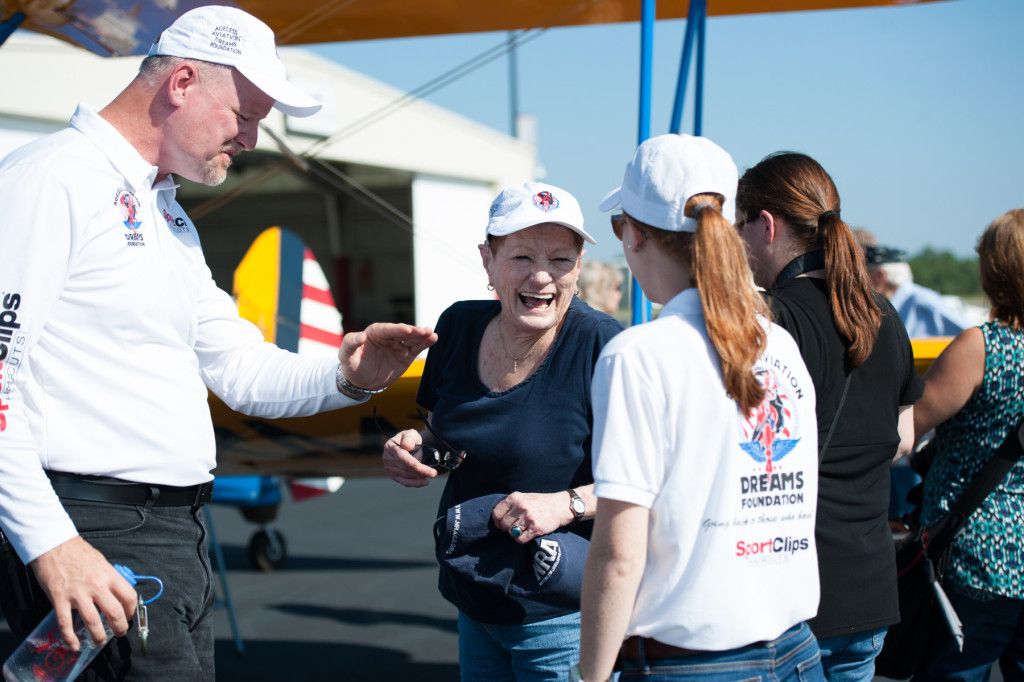 DeeDee Miller laughs with Founder, President and Pilot of Ageless Aviation Darryl Fisher and his daughter Nicole Fisher (far right) after Miller's plane ride at the Moore County Airport on Tuesday, September 1, 2015 in Whispering Pines.