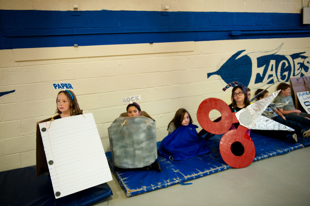 Kaydence Wright (left), Tommie Hussey (center, left), and Kamryn Brown (far right) are dressed up as Paper-Rock-Scissors during the Halloween Costume parade in the gymnasium of High Falls Elementary School on Friday, October 30, 2015 in Robbins, North Carolina.