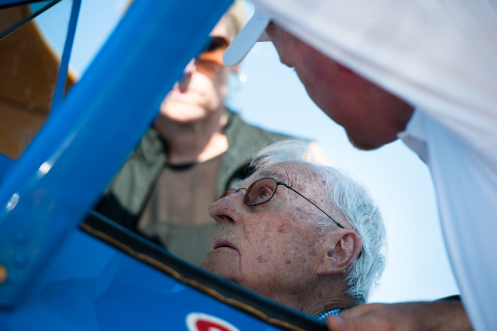 Pilot Darryl Fisher helps Larry Deister into the co-pilot's seat of his Boeing Stearman for Deister's Ageless Aviation plane ride at the Moore County Airport on Tuesday, September 1, 2015 in Whispering Pines.