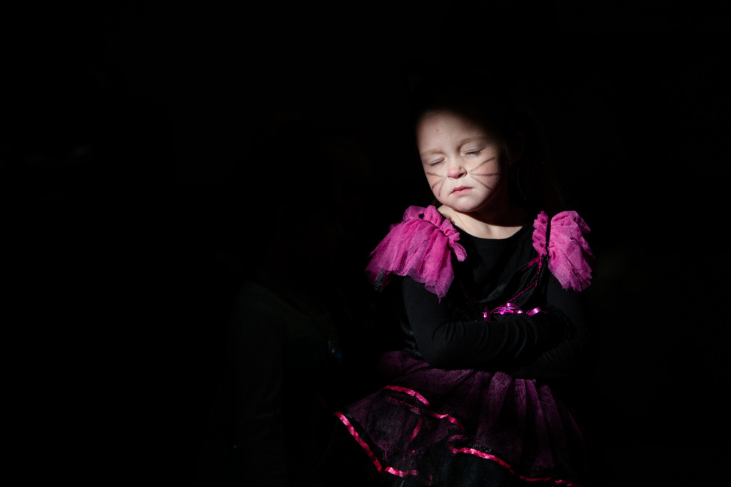 Bands of light stream across the students as they walk during the Halloween Costume parade in the gymnasium of High Falls Elementary School on Friday, October 30, 2015 in Robbins, North Carolina.