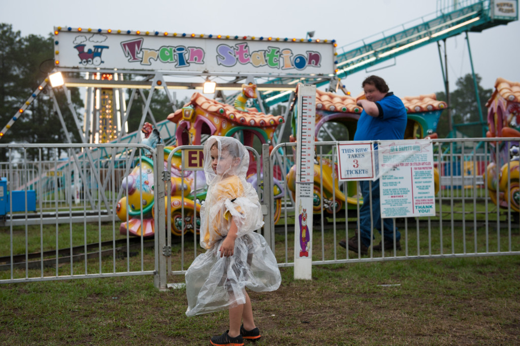 Three-year-old Shawn Ryder waits for his group as he picks the next ride at the Moore County Fair on Thursday, October 1, 2015 in Carthage, North Carolina.