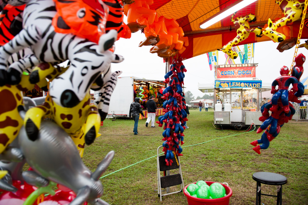 Patrons walk through the drizzly grounds at the Moore County Fair on Thursday, October 1, 2015 in Carthage, North Carolina.