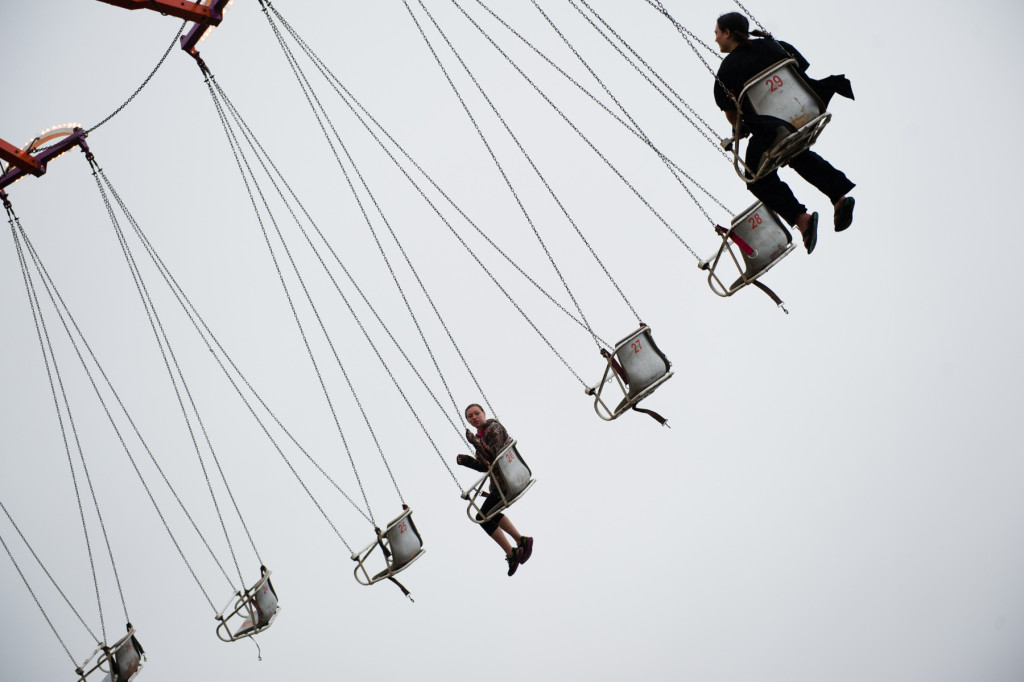 Two patrons ride the giant swing in the rain at the Moore County Fair on Thursday, October 1, 2015 in Carthage, North Carolina.