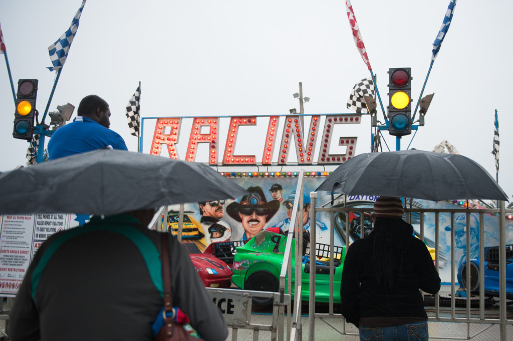 As the rain intensifies, umbrellas are seen across the grounds at the Moore County Fair on Thursday, October 1, 2015 in Carthage, North Carolina.