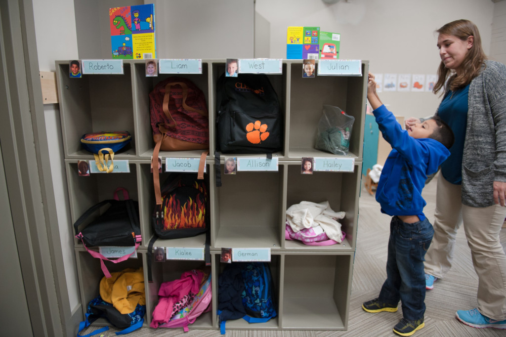 Roberto Villa Hernandez puts his name tag on the attendance board at HOPE Academy, a recently opened pre-school, on Wednesday, September 16, 2015 in Robbins, North Carolina.