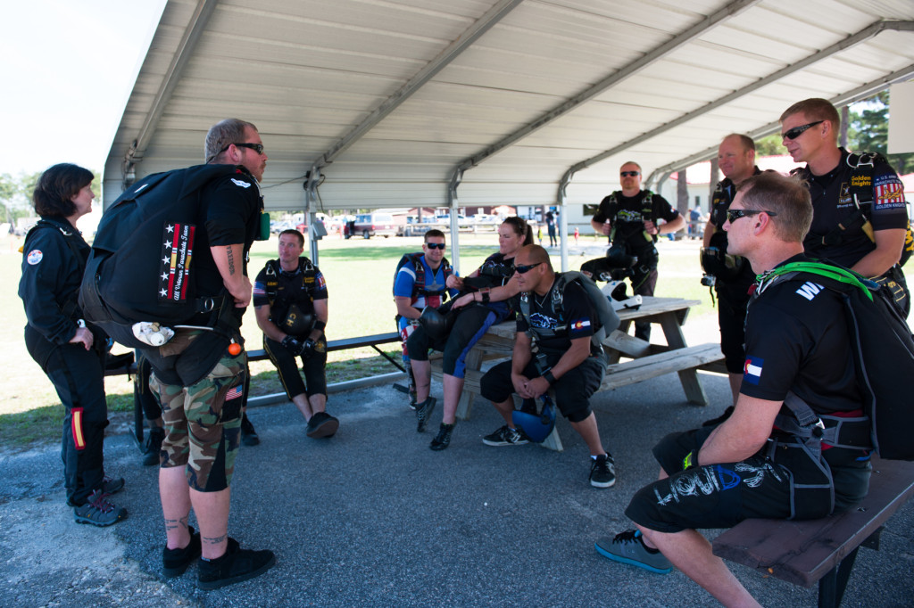 Beth Patterson Casilio and Robbie Rushton stand with other jumpers who are waiting for their plane at the Raeford Drop Zone on Thursday, October 8, 2015 in Raeford, North Carolina.