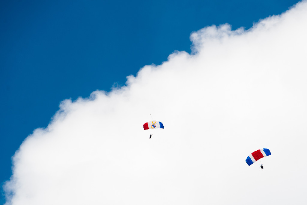 Beth Patterson Casilio, with her tandem instructor Robbie Rushton, and Steven Cox with his tandem instructor Mike Elliott, are seen in the sky after jumping from a plane at 14, 000 feet at the Raeford Drop Zone on Thursday, October 8, 2015 in Raeford, North Carolina.