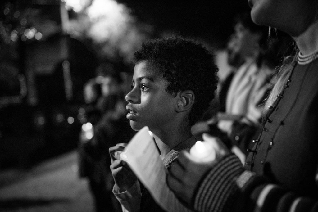 Ten-year-old Godwin Linder watches the stage during a candlelight vigil for the homeless, in support of National Homeless Persons' Memorial Day, on Monday, December 21, 2015 hosted by St. Joseph of the Pines, at Downtown Park in Southern Pines, North Carolina.