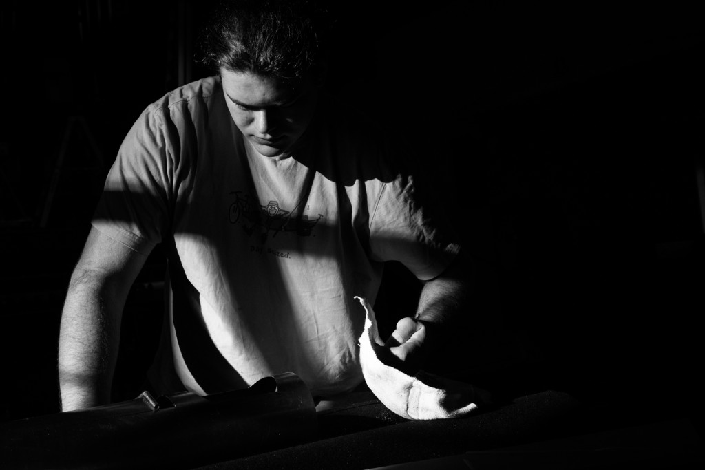 A shadow casts a cross over Caleb Ringwald as he cuts windows into the back of a front pipe, for tuning, while helping complete the build of a new mechanical-action organ at Emmanuel Episcopal Church on Tuesday, December 15, 2015 in Southern Pines, North Carolina.