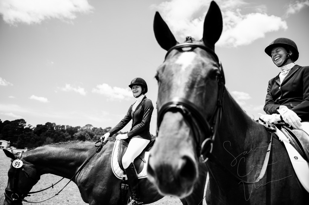 Lisa Wall (right), of Apex, North Carolina, sits on her horse Baaron Miller Rh as she smiles and laughs with her daughter Olivia Wall (left), who's sitting on her horse Mandolin R, as they wait for their scheduled riding times during the Dressage in the Sandhills Horse Show at the Pinehurst Harness Track on Friday, May 8, 2015 in Pinehurst, North Carolina.