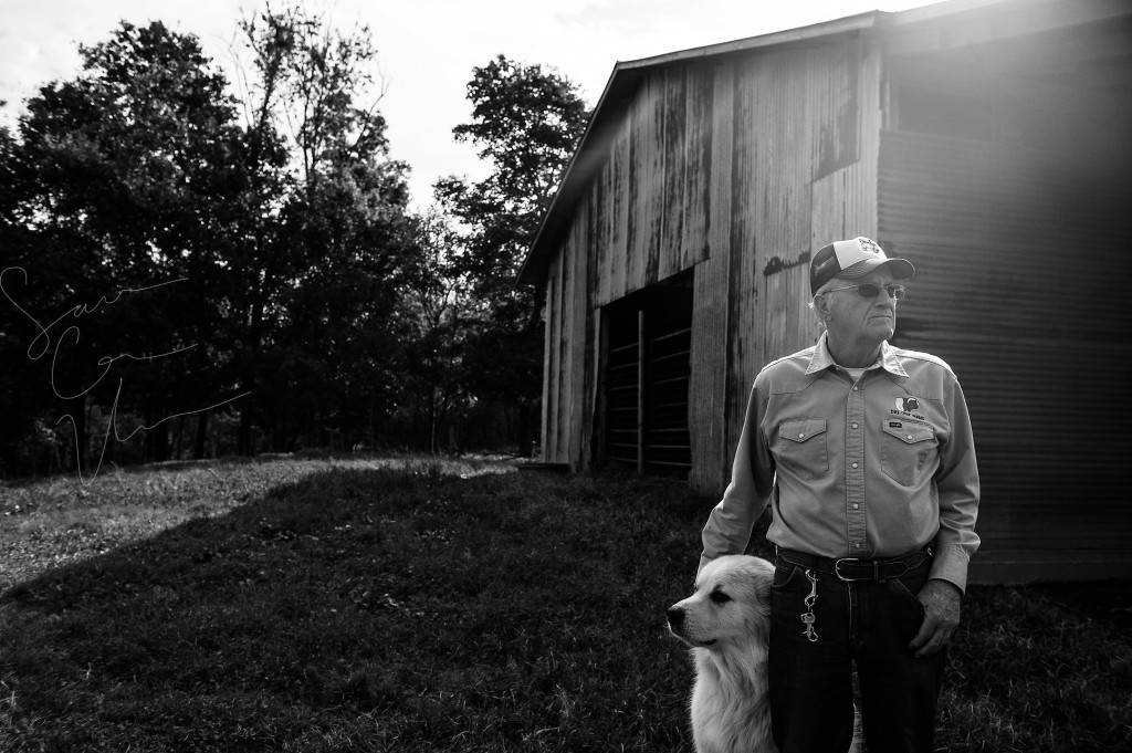 Jackie Bean pets Joe, the farm's dog, at D and J Goat Farms on Friday, October 16, 2015 near Robbins, North Carolina. Jackie Bean and his son Derek Bean have been raising livestock for years, specializing in goats for almost a decade. The farms produce commercial stock, breeding stock and show stock Boer goats.