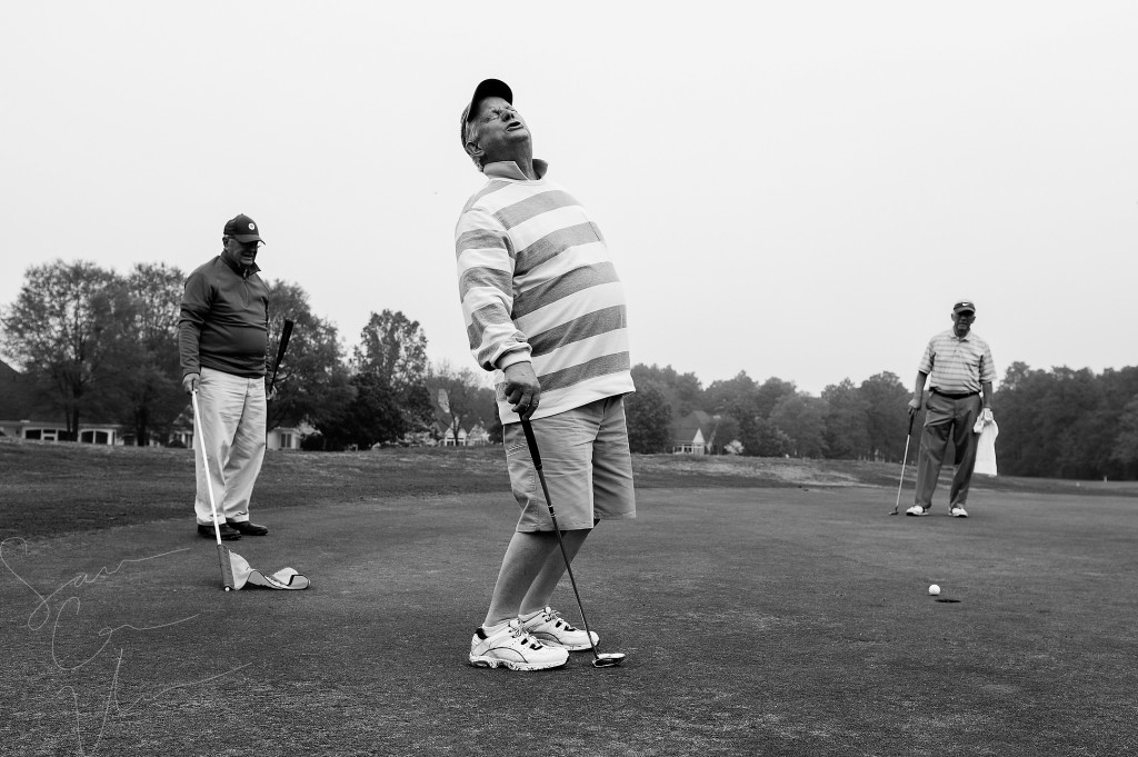 Woody Tanner (left) and Lyle Cooper (right) watch as Bob Lamoree (center) reacts after missing a putt at the one green while playing a round with friends from Midloathian, Virginia at Longleaf Golf and Country Club on Friday, April 17, 2015 in Southern Pines, North Carolina.