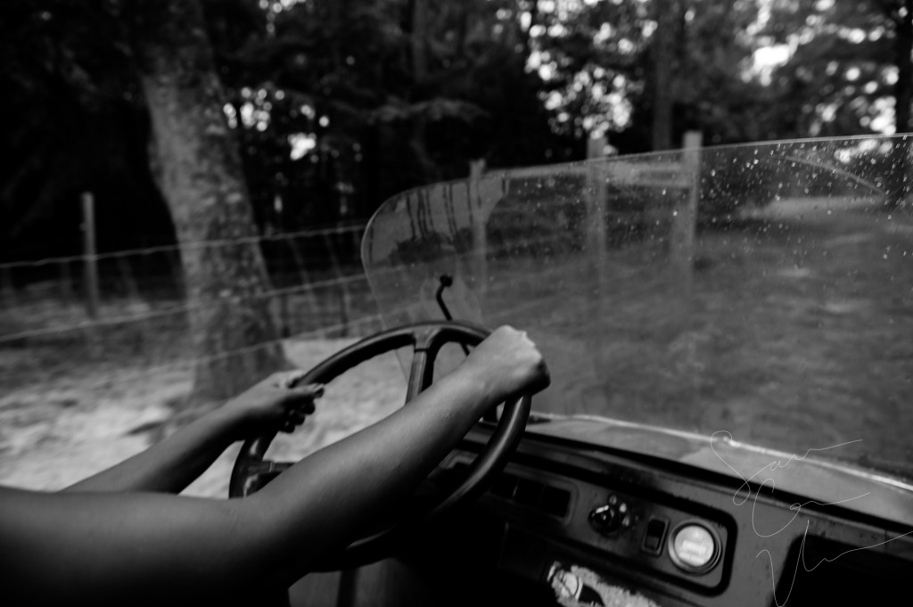 Volunteer Tema Toure drives a utility vehicle around the land on her morning feeding round at Paradox Farm on Tuesday, July 14, 2015 in West End, North Carolina.