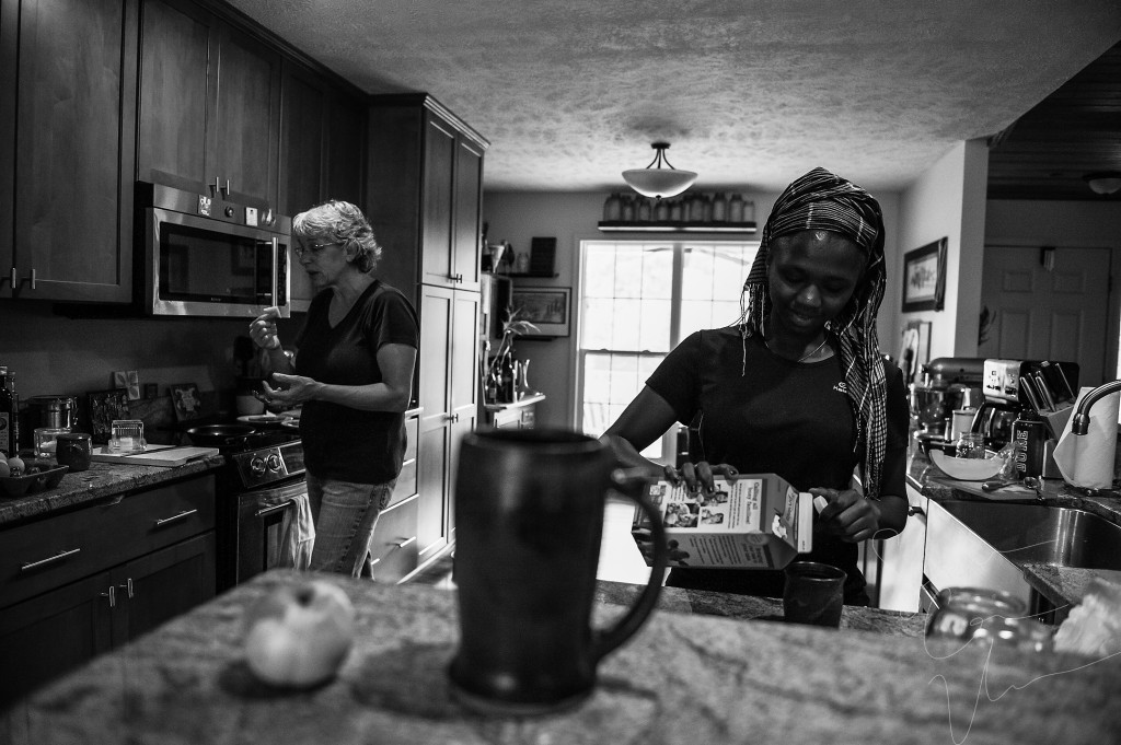 Sue Stovall makes breakfast after an early morning of milking goats, as Tema Toure, the volunteer, pours creamer in her coffee, in the main house at Paradox Farm on Tuesday, July 14, 2015 in West End, North Carolina.